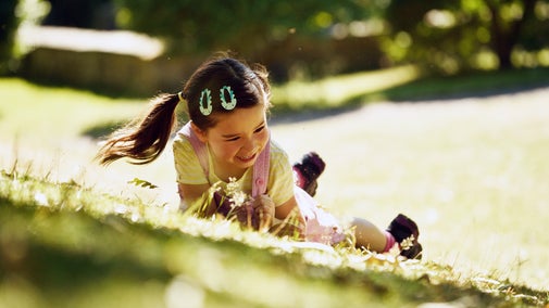 Girl rolling down a hill